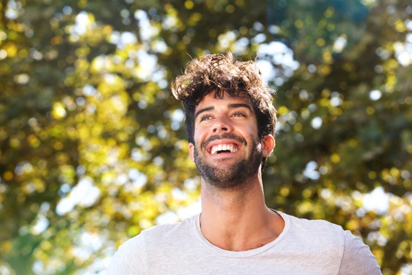 close up laughing man with beard outside