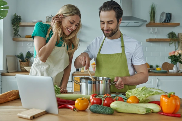 happy young couple cooking together